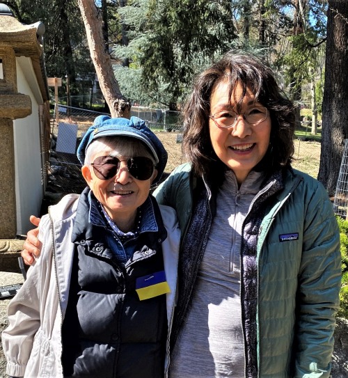 Hideko with Noriko stand together just outside the front gate of the Japanese garden